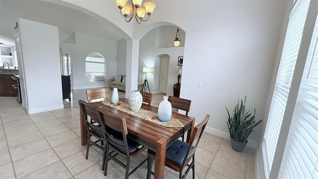 dining room with light tile patterned flooring and an inviting chandelier