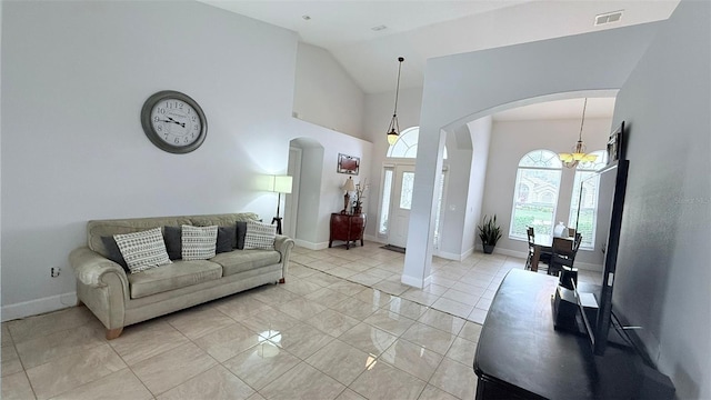 tiled living room featuring lofted ceiling