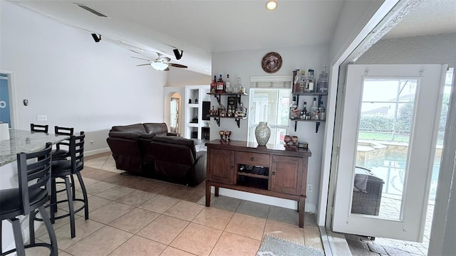 interior space with vaulted ceiling and ceiling fan