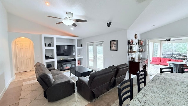 living room featuring a textured ceiling, light tile patterned floors, lofted ceiling, and french doors