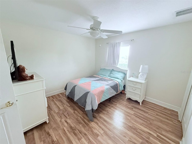 bedroom with ceiling fan and light hardwood / wood-style flooring