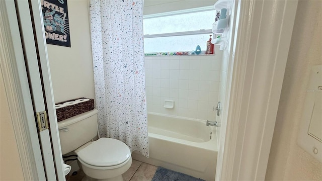 bathroom featuring shower / bath combo with shower curtain, toilet, and tile patterned flooring