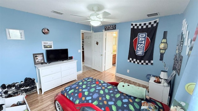 bedroom with ceiling fan, light hardwood / wood-style flooring, and ensuite bath