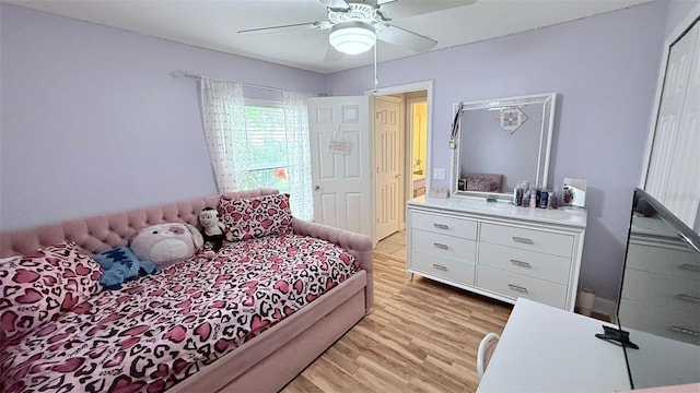 bedroom with light hardwood / wood-style floors and ceiling fan