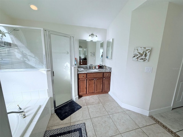 bathroom with tile patterned flooring, vanity, and shower with separate bathtub