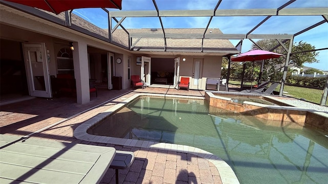 view of pool with an in ground hot tub, a lanai, and a patio