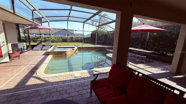 view of swimming pool featuring glass enclosure, an in ground hot tub, and a patio