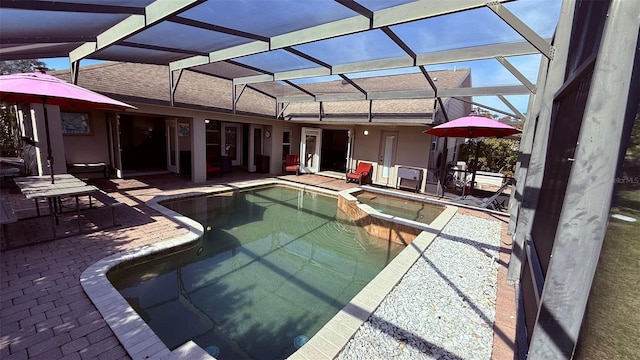 view of swimming pool featuring glass enclosure, a patio area, and an in ground hot tub