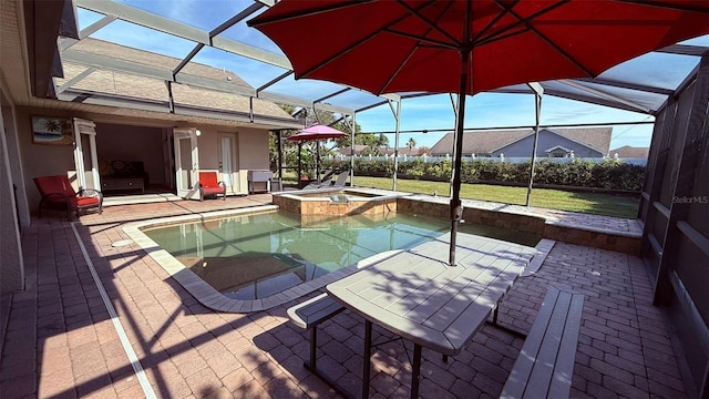 view of pool with an in ground hot tub, a lanai, and a patio area