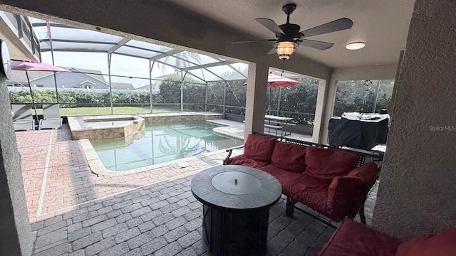 view of pool with an in ground hot tub, a patio area, glass enclosure, and ceiling fan