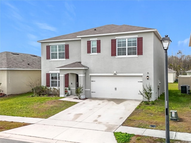 view of front of house featuring a garage, cooling unit, and a front lawn