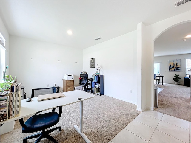 carpeted office space with plenty of natural light