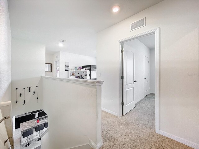 hallway with light carpet