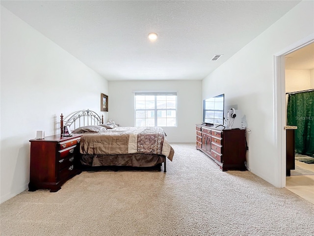 carpeted bedroom featuring a textured ceiling