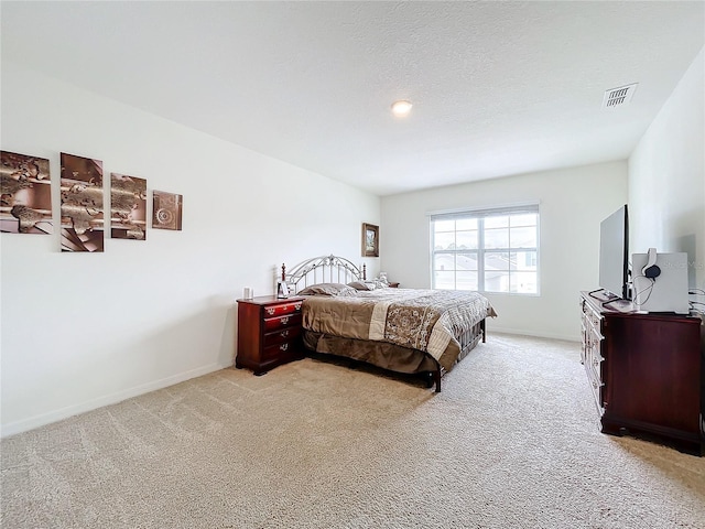 carpeted bedroom with a textured ceiling