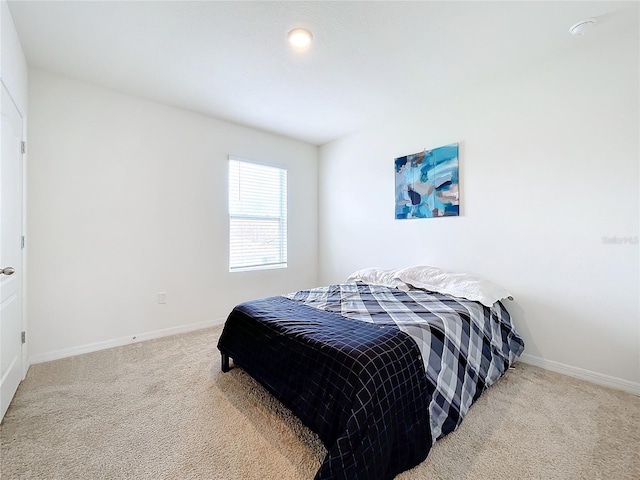 bedroom featuring light carpet