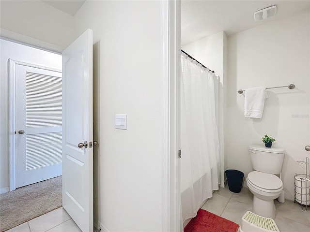 bathroom featuring toilet and tile patterned flooring