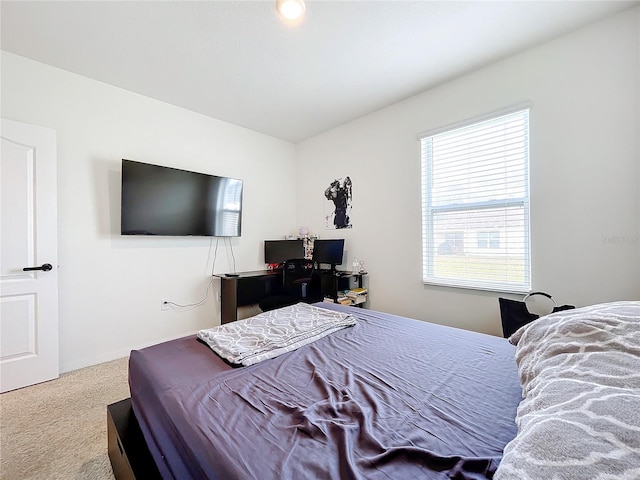 bedroom featuring light carpet