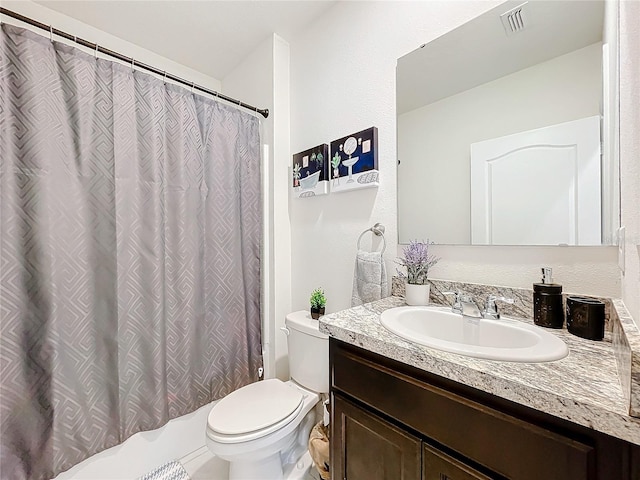 bathroom featuring toilet and vanity