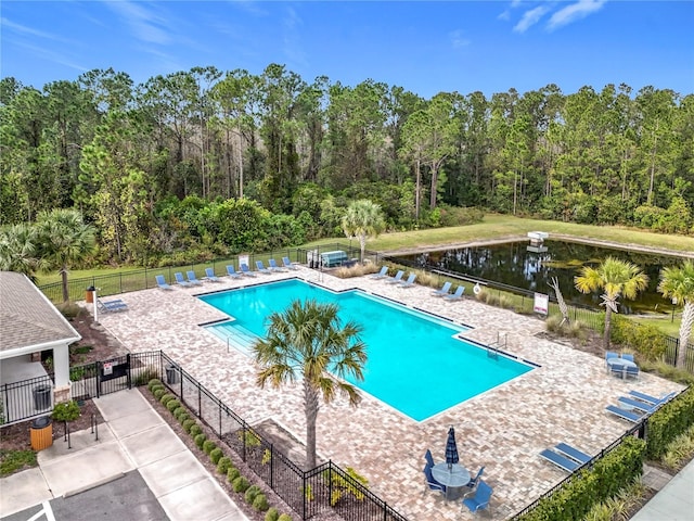 view of swimming pool featuring a patio area and a water view