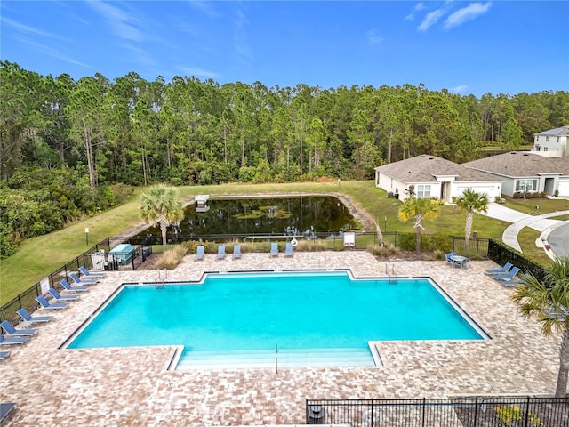 view of pool featuring a patio and a yard