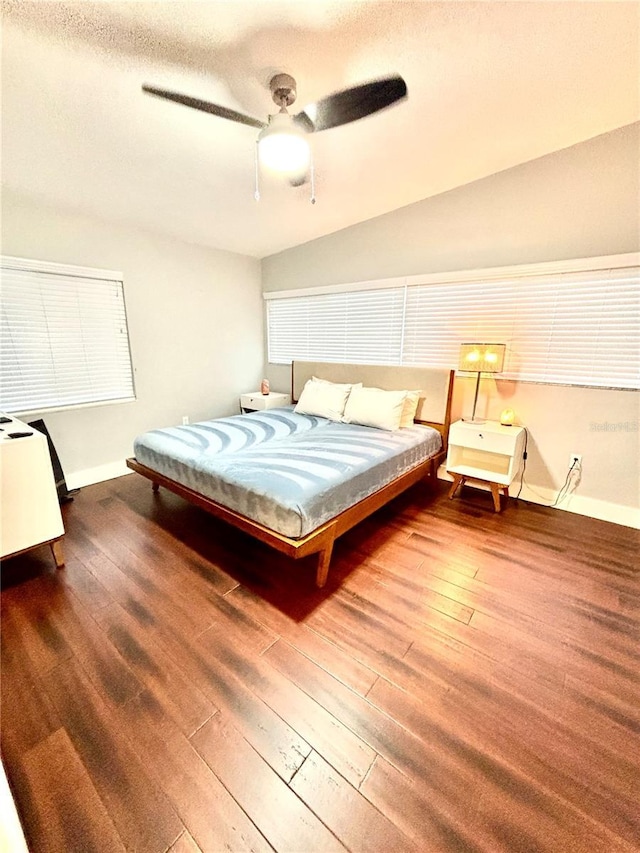 bedroom with a textured ceiling, wood-type flooring, and ceiling fan