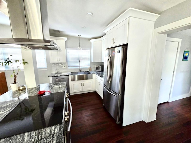 kitchen with sink, light stone counters, hanging light fixtures, island exhaust hood, and stainless steel appliances