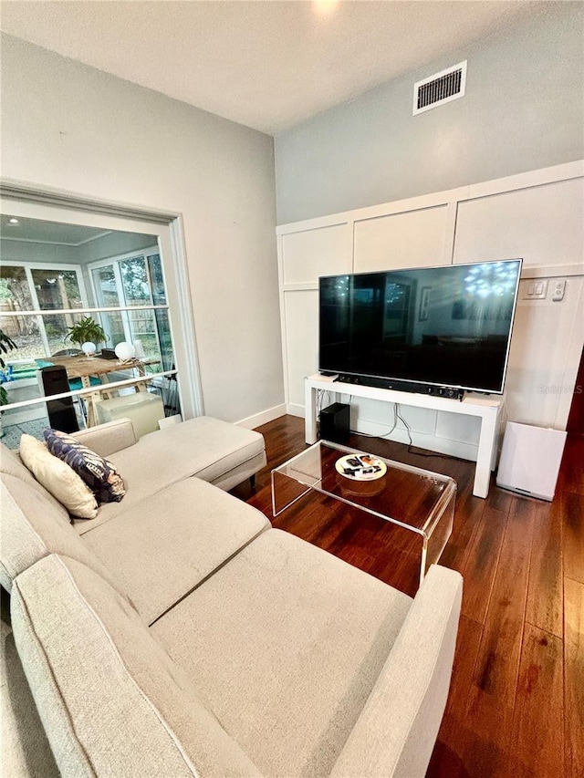 living room with dark hardwood / wood-style flooring