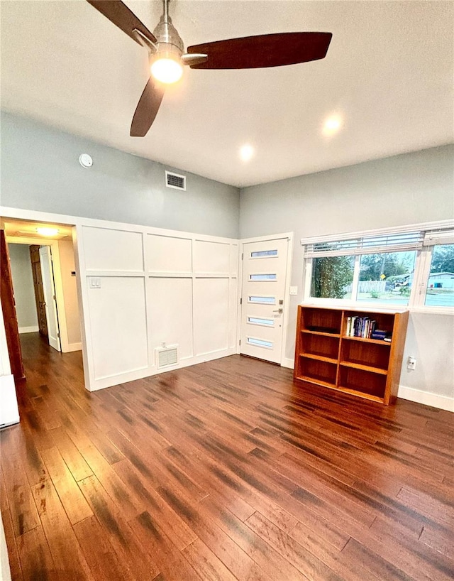 unfurnished living room with ceiling fan and dark hardwood / wood-style flooring