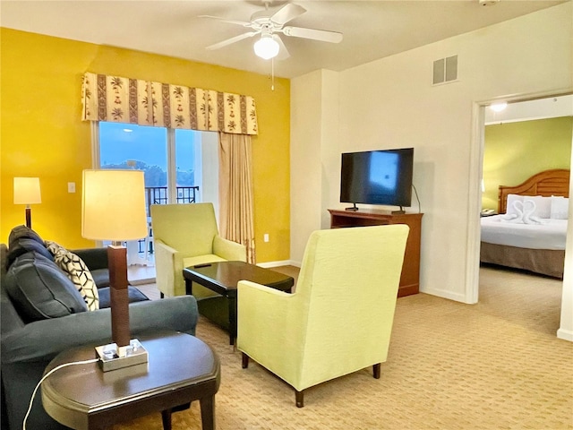 carpeted living room with ceiling fan