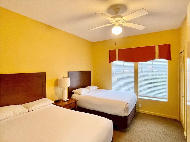 bedroom featuring ceiling fan, a closet, and carpet