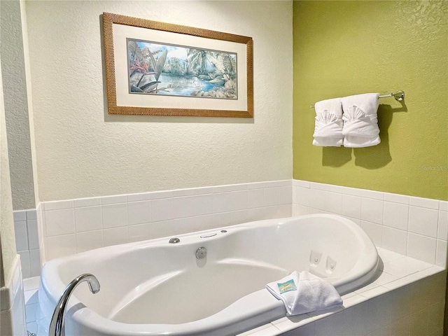 bathroom featuring tiled tub