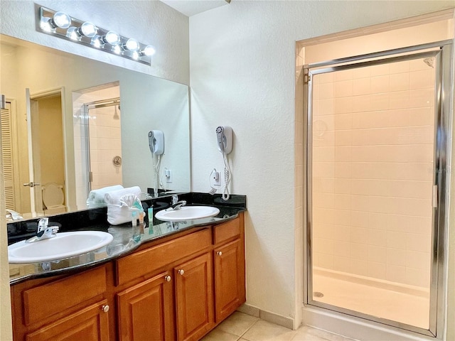 bathroom with vanity, tile patterned floors, and walk in shower