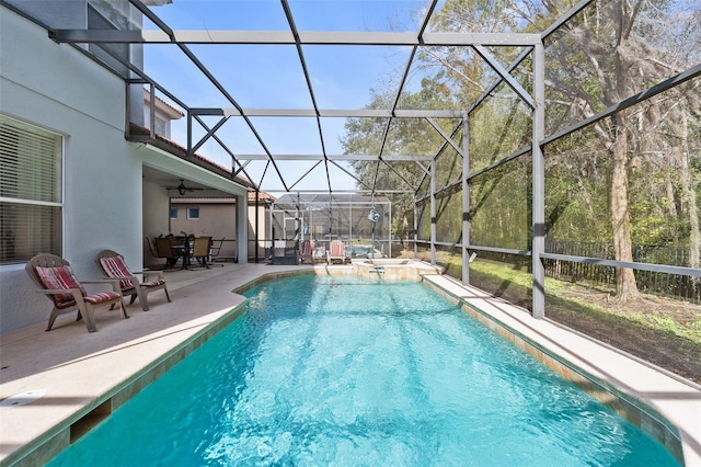 view of swimming pool with an in ground hot tub, a patio area, and a lanai