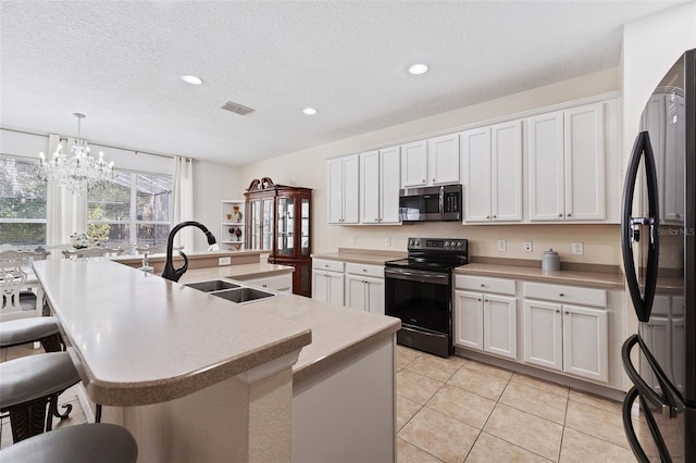 kitchen with white cabinetry, appliances with stainless steel finishes, and hanging light fixtures