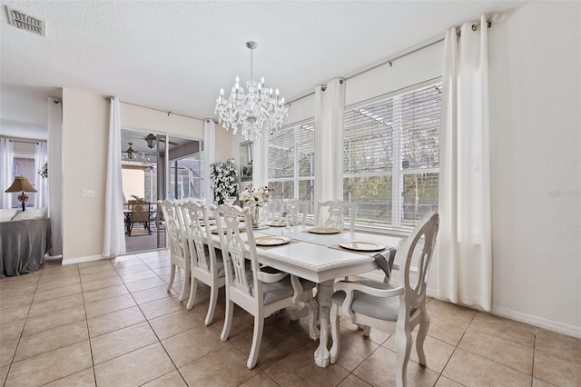 dining area with a wealth of natural light, light tile patterned floors, and a textured ceiling