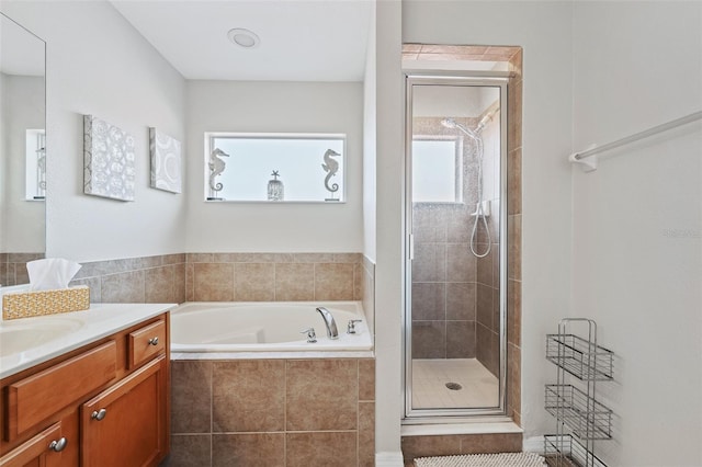 bathroom featuring vanity and plus walk in shower