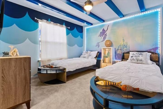 carpeted bedroom featuring ceiling fan and beamed ceiling