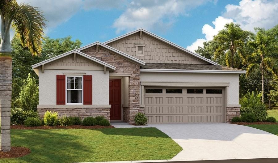 craftsman-style house featuring a garage and a front lawn