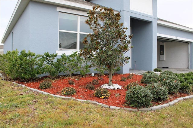 1280 Tupelo Trl, Haines City, FL 33844 - view of side of home with a garage and a lawn