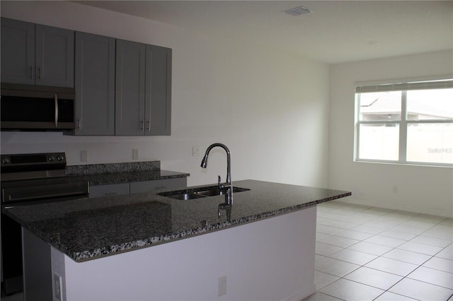 1280 Tupelo Trl, Haines City, FL 33844 - kitchen with black / electric stove, sink, light tile patterned floors, and dark stone counters
