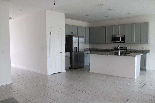 1280 Tupelo Trl, Haines City, FL 33844 - kitchen featuring stainless steel appliances, sink, a kitchen island with sink, and light tile patterned floors