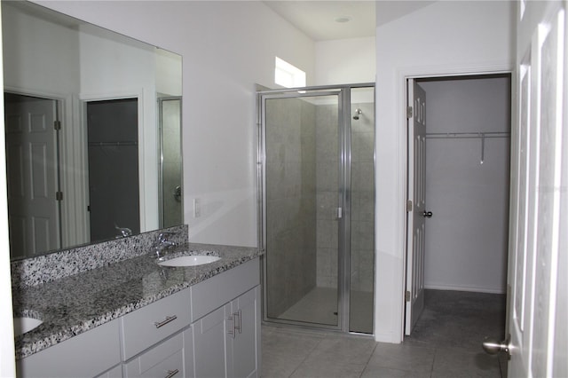 1280 Tupelo Trl, Haines City, FL 33844 - bathroom featuring vanity, tile patterned flooring, and a shower with door