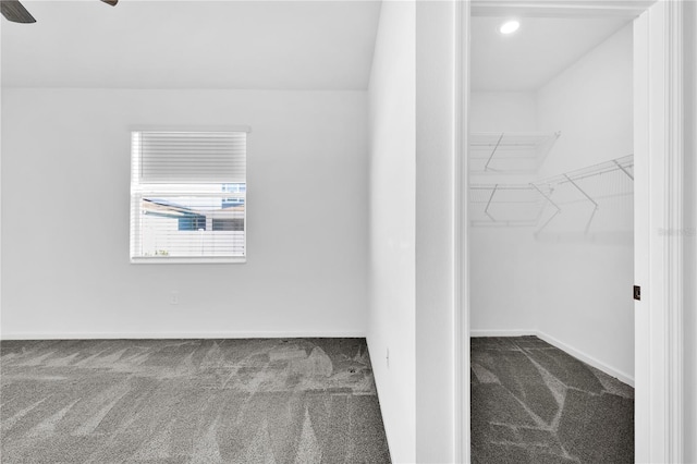 walk in closet with ceiling fan and carpet floors