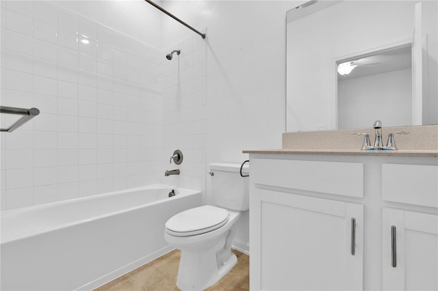 full bathroom featuring vanity, tiled shower / bath, tile patterned floors, and toilet