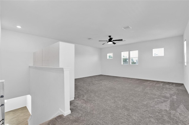 spare room featuring ceiling fan and carpet