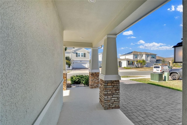 view of patio with covered porch and a residential view