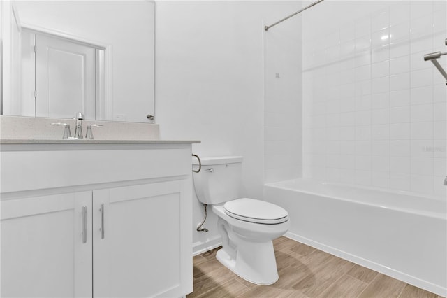 full bath with vanity, bathing tub / shower combination, wood finished floors, and toilet