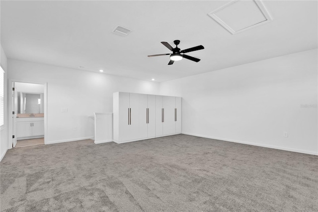 interior space with attic access, carpet flooring, visible vents, and baseboards