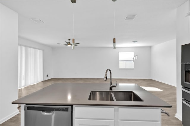 kitchen with open floor plan, visible vents, dishwasher, and a sink